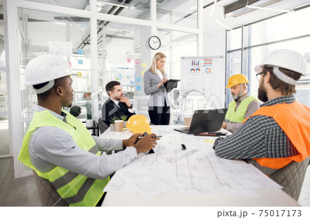 Business people discussing project plan in details 75017173