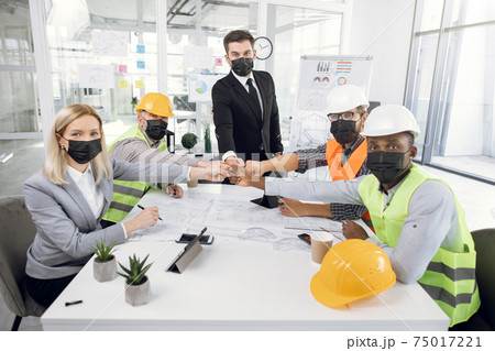 Multicultural people in masks having conference at office Multicultural people in masks having conference at office 75017221
