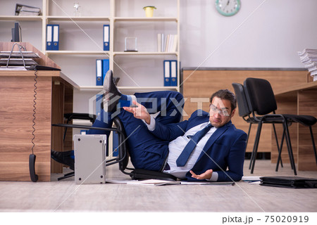 Young male businessman employee unhappy with his work 75020919