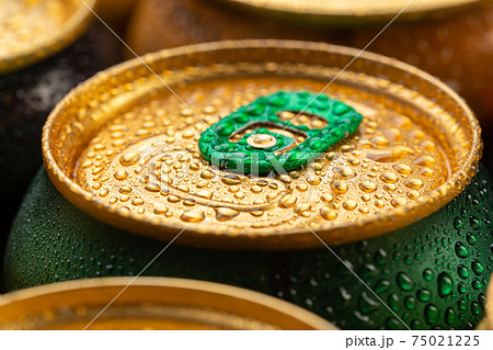 Cold metal beer cans with water drops. Alcoholic drink. Cold metal beer cans with water drops. Alcoholic drink. 75021225