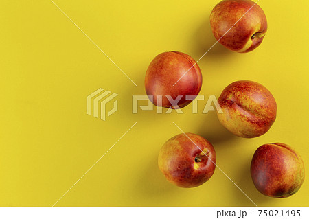 Ripe nectarine on a yellow background. Fresh fruits. Ripe nectarine on a yellow background. Fresh fruits. 75021495
