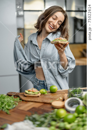 Happy slim woman showing her weight loss Happy slim woman showing her weight loss 75022614