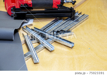 concept of furniture production and repair. Stapler and staples, working tool 75023391