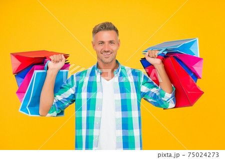 cheerful man shopaholic buy many gift packs in mall, black friday 75024273