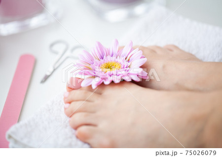 Cheerful Girl Doing Nails Making Pedicure Sitting In Bed Indoor. 75026079