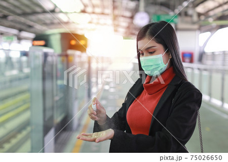 New normal covid-19 epidemic, young smart business asian woman wearing mask protection for prevent virus covid-19 or coronavirus infection from people in train, using alcohol spray hand sanitiser New normal covid-19 epidemic, young smart business asian woman wearing mask protection for prevent virus covid-19 or coronavirus infection from people in train, using alcohol spray hand sanitiser 75026650