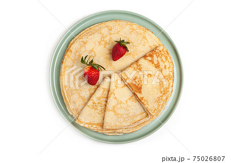 Pancake on the green plate on white background Pancake on the green plate on white background 75026807