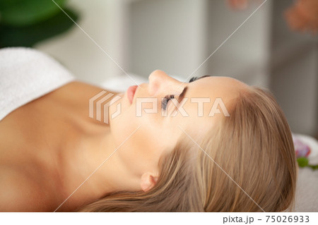 Face Massage, Close-up of a Young Woman Getting Spa Treatment. 75026933