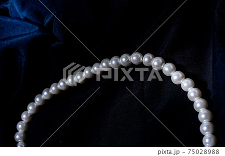 Pearl necklace, Pearl necklace against a dark background Pearl necklace, Pearl necklace against a dark background 75028988