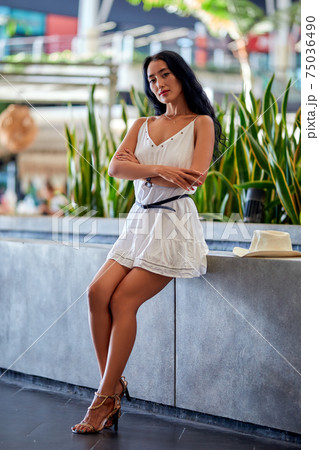 Young beautiful asian woman sitting at the table in cafe 75036490