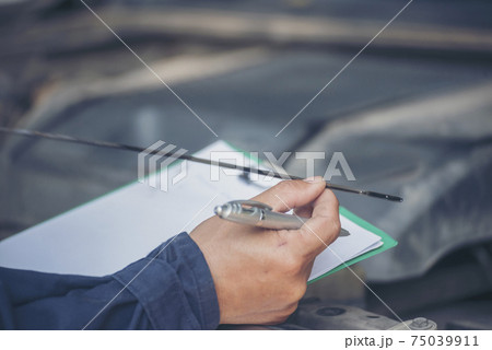 Mechanic man hands checking car tires outdoor on site service auto garage for automotive mobile Mechanic man hands checking car tires outdoor on site service auto garage for automotive mobile 75039911