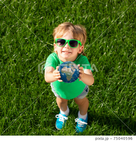 Child holding Earth planet in hands. Elements of this image furnished by NASA 75040596