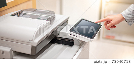 Male hand pushing button on photocopier 75040718