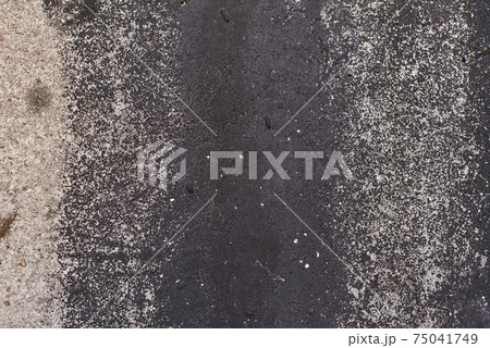 Grey texture of old broken asphalt road or wall big abrasions cracks holes on the surface pebbles cement in Sofia, Bulgaria, Eastern Europe 75041749