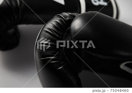 Pair of black boxing gloves on white background, closeup 75048460