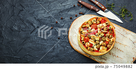 Cheese pie with peppers and olives. 75049882