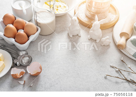 Easter culinary background. Easter food ingredients composition on the kitchen table and space for a text menu or recipe. Easter culinary background. Easter food ingredients composition on the kitchen table and space for a text menu or recipe. 75050118