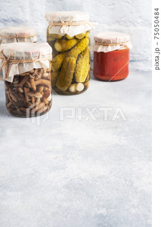 Preservation of vegetables in banks. Fermentation products. Harvesting cucumbers and mushrooms for the winter. Copy space. 75050484