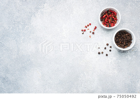 Pepper peas black and red in plates, gray concrete background, copy space. 75050492