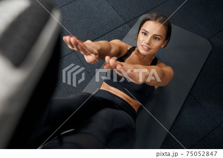 Cute woman working with abs in gym. Cute woman working with abs in gym. 75052847