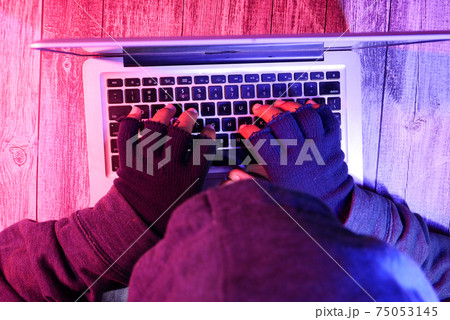 hacker hand stealing data from laptop top down hacker hand stealing data from laptop top down 75053145