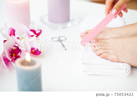 Cheerful Girl Doing Nails Making Pedicure Sitting In Bed Indoor. 75053422