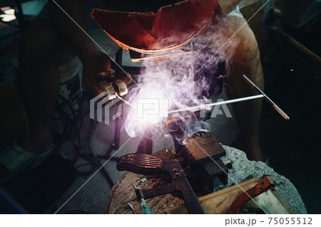 Man hand  Industrial worker welding metal at factory workshop 75055512