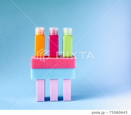 Colorful washcloths, plastic travel bottles and bars of soap on a soft background. Accessories for body care and hygiene. Colorful washcloths, plastic travel bottles and bars of soap on a soft background. Accessories for body care and hygiene. 75060645