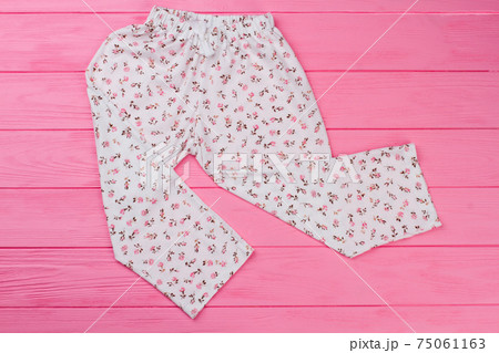 Loose pants on pink background Loose pants on pink background 75061163