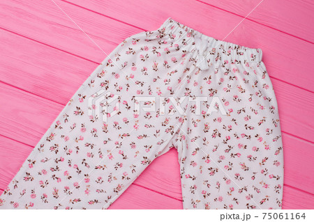 Girls' pants on pink background 75061164