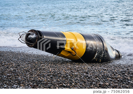 damaged sea buoy - cardinal danger mark - washed ashore after a storm damaged sea buoy - cardinal danger mark - washed ashore after a storm 75062056