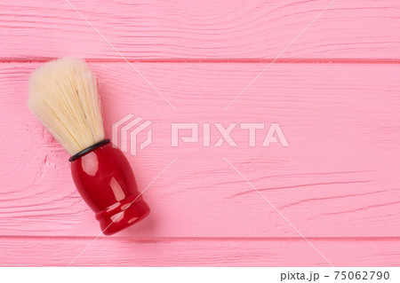 Shaving brush on a wooden background. 75062790