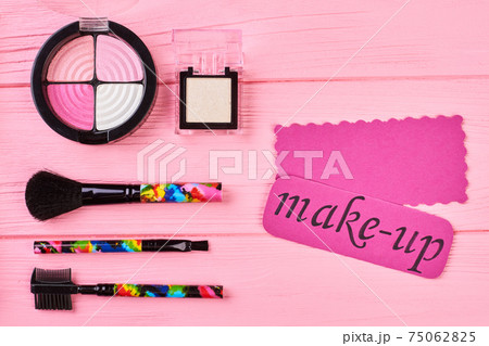 Pink shiny eyeshadows on colorful background. Pink shiny eyeshadows on colorful background. 75062825
