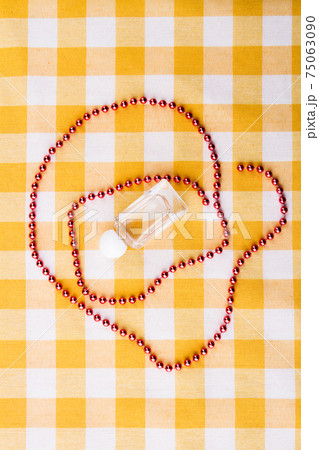 Composition of perfume bottle and bead necklace. Composition of perfume bottle and bead necklace. 75063090
