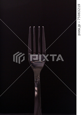 Stainless fork on black background. Stainless fork on black background. 75063219