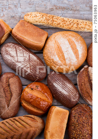 Variety of organic bread on wooden background. 75063963