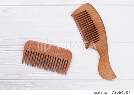 Wooden hair combs on white background. Wooden hair combs on white background. 75064204