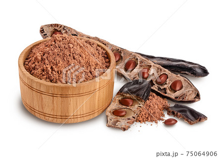 Carob pod and powder in wooden bowl isolated on white background with clipping path and full depth of field. 75064906