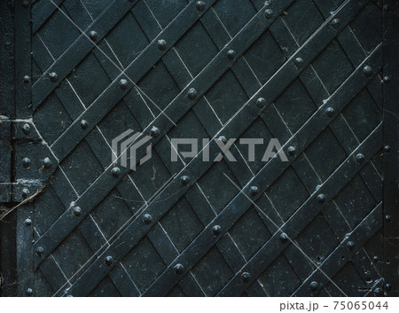 Vintage metal background, forged metal door, robust Vintage metal background, forged metal door, robust 75065044