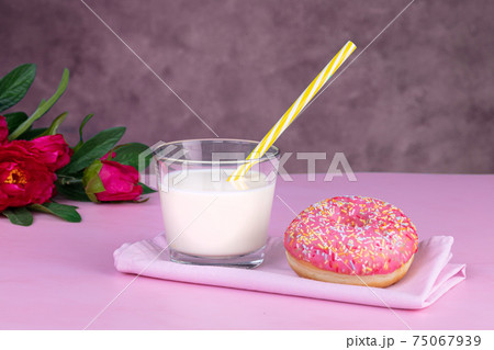 Pink donut with a glass of milk 75067939