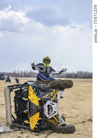 ATV UTV overturned, the rider sits near the broken all-terrain vehicle 75071209