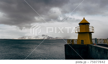 A large yellow lighthouse in Iceland, Reykjavik. 75077642