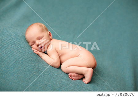 2. Newborn baby boy sleeping at a newborn photoshoot with his hands under his cheeks 2. Newborn baby boy sleeping at a newborn photoshoot with his hands under his cheeks 75080676