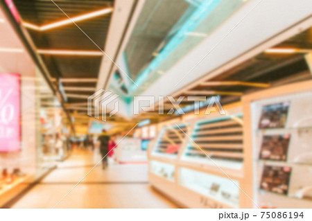 Young people shopping mall blurred background. Interior of retail centre store in soft focus. People shopping in modern commercial mall center. Fashion market hall. 75086194