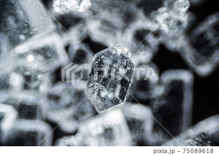 Crystal sugar close up on black background under the light microscope with a magnification of 40 times 75089618