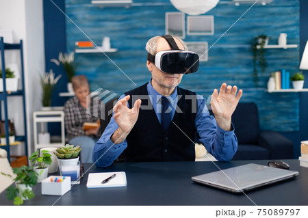 Cheerful old man wearing virtual reality headset Cheerful old man wearing virtual reality headset 75089797