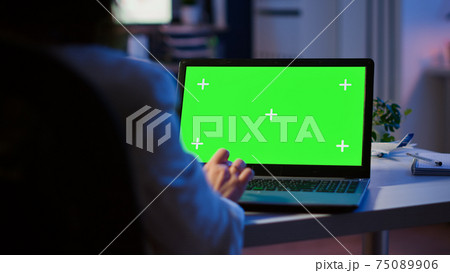 Close up of freelancer typing on laptop with green screen overtime Close up of freelancer typing on laptop with green screen overtime 75089906