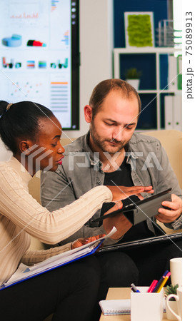 Diverse businesspeople analysing financial project during corporate meeting 75089913