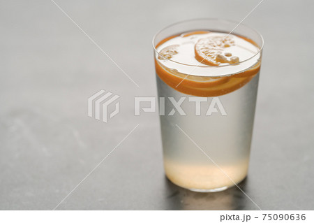 organic lemonade in tumbler glass on concrete background with copy space 75090636