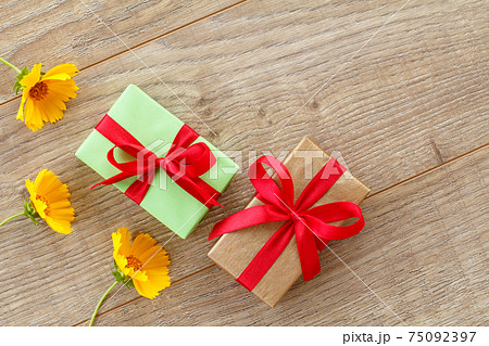 Gift boxes with calendula flowers on the wooden background. Gift boxes with calendula flowers on the wooden background. 75092397